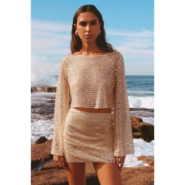 Mid rise mini skirt in a macadamia sequin and bead embellished mesh.