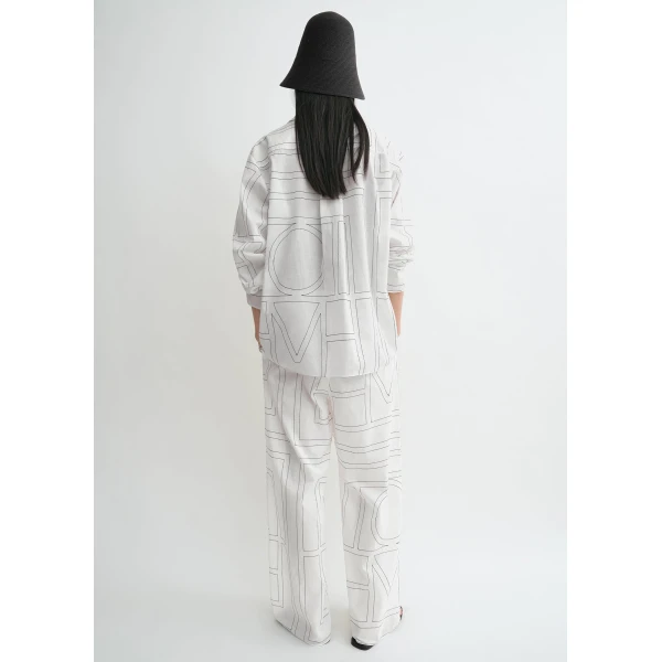 Totême Monogram cotton-blend pj top in White / Black - Tops - Scandinavian Minimalist Luxury at Luxury Shoes 