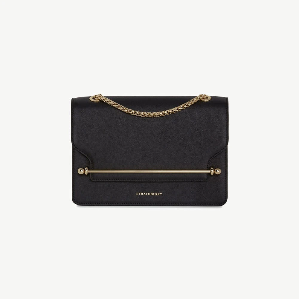 Strathberry East/West in black calf leather, the crossbody bag with the signature metal bar closure made globally known by Meghan Markle
