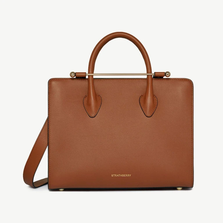 Strathberry Midi Tote in chestnut leather, a structured top-handle tote with the signature bar closure, an accessible-luxury alternative to DeMellier and Polene